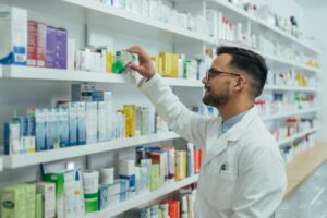 handsome pharmacist working in a pharmacy.jpg