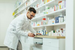 portrait of a handsome pharmacist working in a pharmacy.jpg