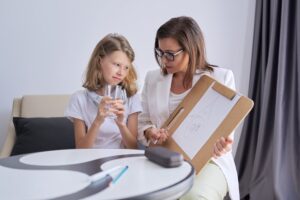 professional counseling for children psychologist looks at childs drawing.jpg
